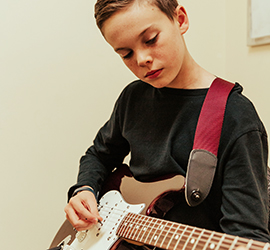A boy playing electric guitar