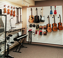 Guitars, violins, drums, and a piano up against the wall