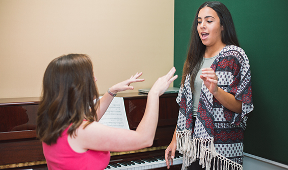 Vocalist teacher practicing with student