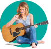 songwriter-class Woman sitting holding a guitar writing notes